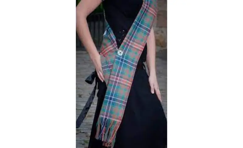 wearing a tartan sash